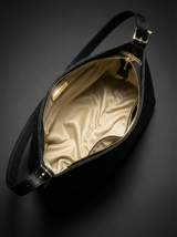 The Houle Petite in Noir, open to show the cream lining