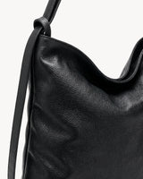 The Embellie Carryall in Noir, close-up of the strap and hardware detail