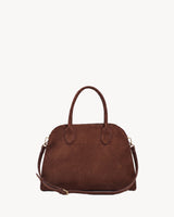 The Aurore Suede Satchel in Chocolate with detachable shoulder strap clipped to the side rings