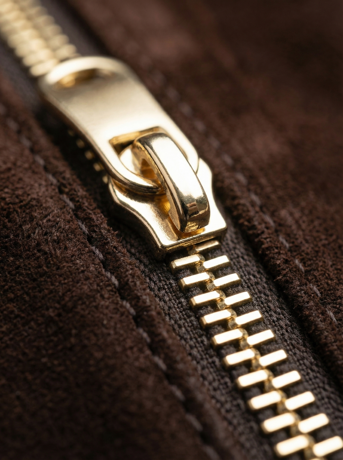 Close-up of the gold zip on the brown suede of The Houle Petite Suede in Chocolate