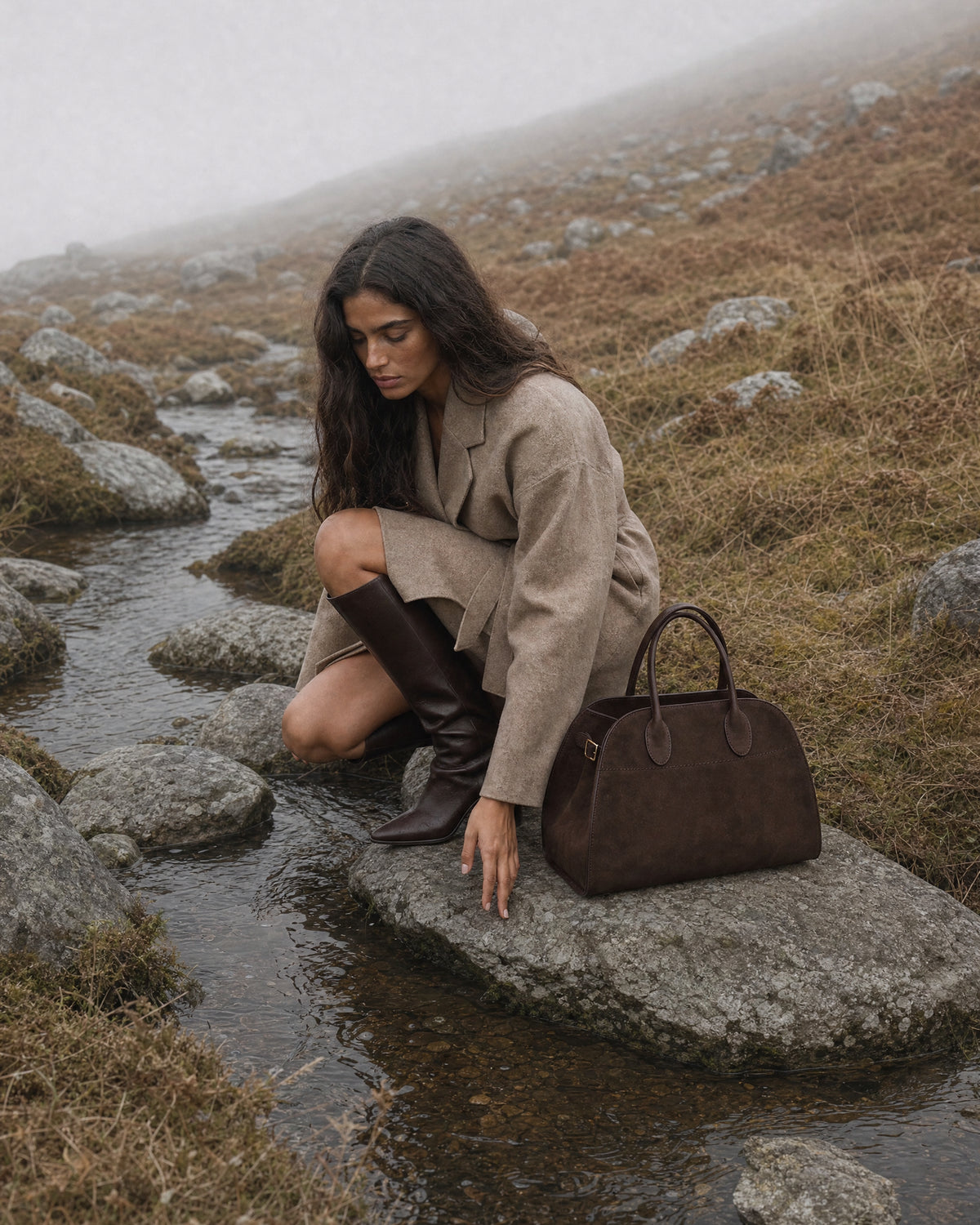 The Aurore Suede Satchel in Espresso, in the misty hills