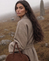 The Aurore Suede Satchel in Chocolate, in the misty hills