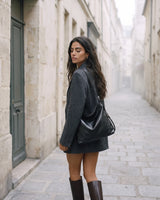 The Jusant in Noir carried in a quiet stone street