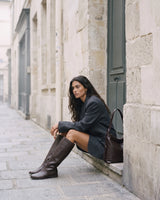 The Jusant in Chocolate beside her on a stone step